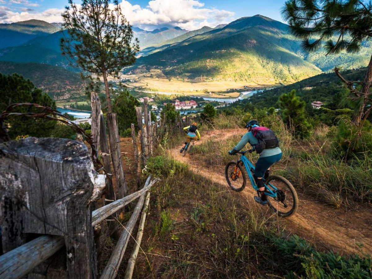 Cyclists on Bhutan cycling tour through traditional villages