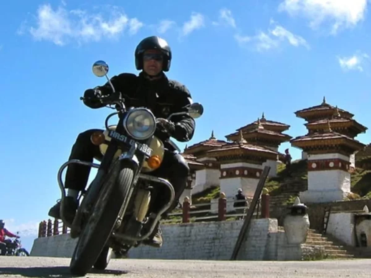 Bhutan Motorcycle Tour 2026 – Royal Enfield riders cruising through Himalayan mountain roads